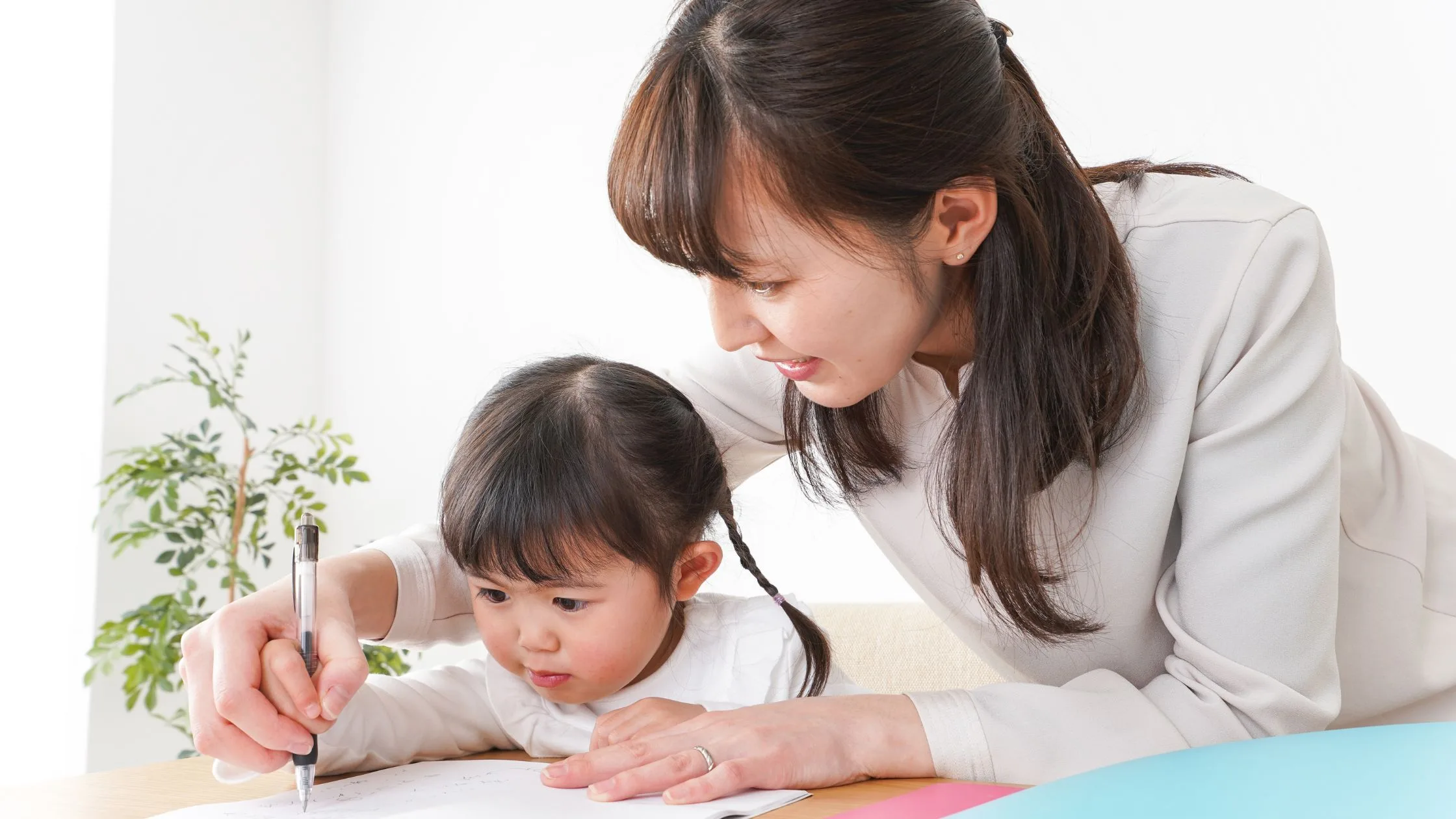 Early childhood assistant guiding a young child's learning